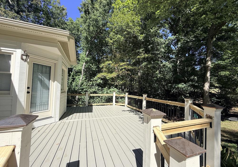 Gray composite deck with new railing after resurfacing by JeDi Works