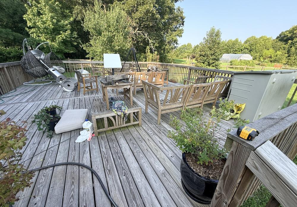 Weathered gray wood deck before sanding and staining
