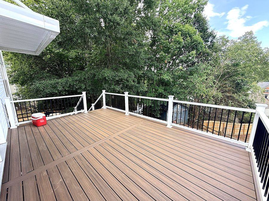Trex composite deck with white railing and black balusters